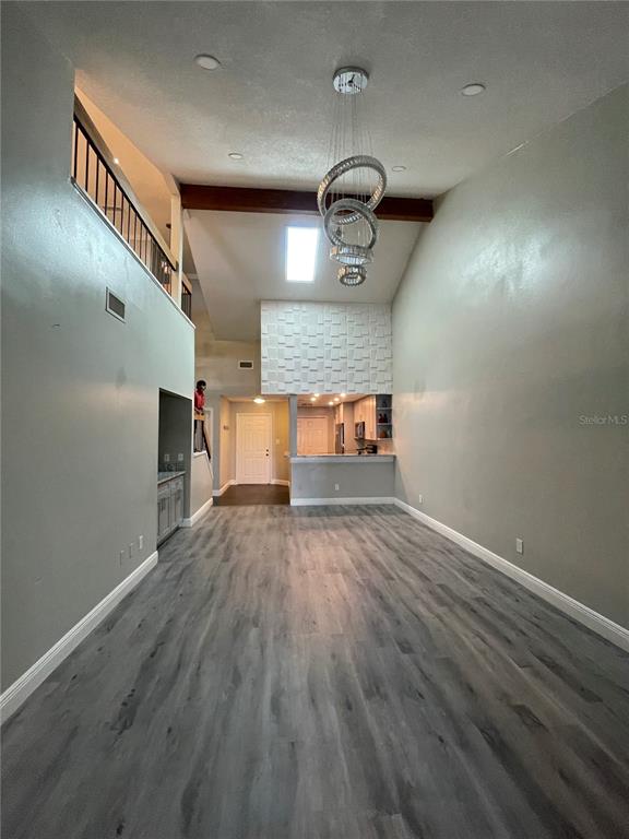 7652 Spring Bay Cove, Unit 3 Orlando, FL 32819 - Photo 8 of 30 a view of empty room with wooden floor