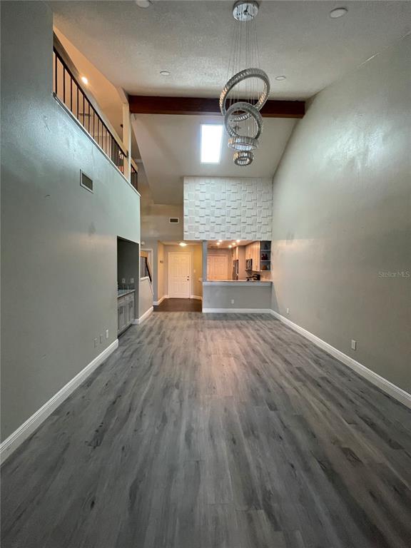 7652 Spring Bay Cove, Unit 3 Orlando, FL 32819 - Photo 9 of 30 a view of a room with wooden floor