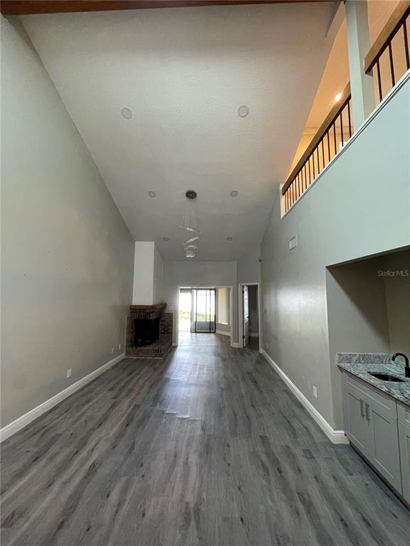 7652 Spring Bay Cove, Unit 3 Orlando, FL 32819 - Photo 10 of 30 a view of a living room a fireplace with wooden floor