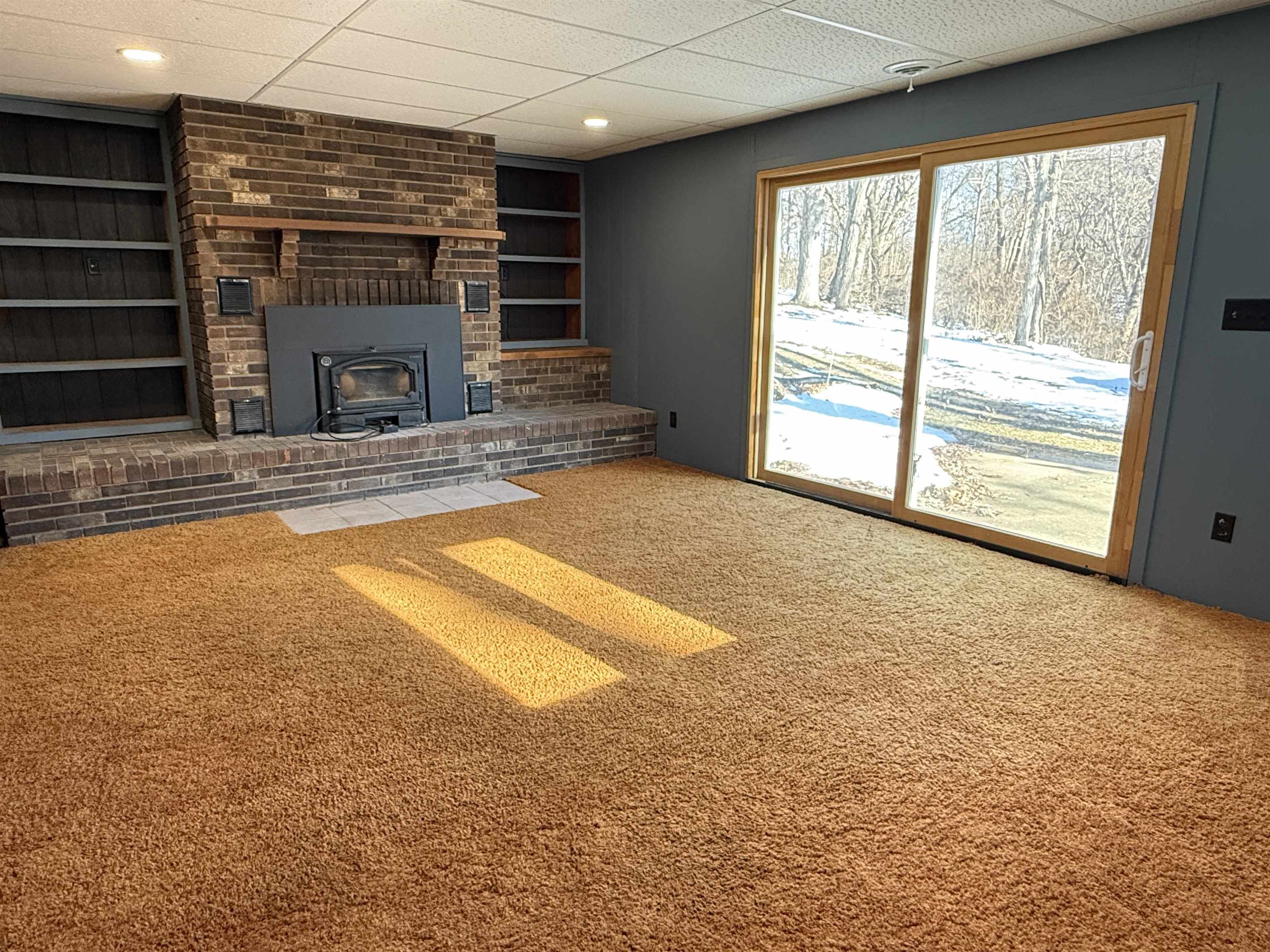 45 South Blackhawk Road Oregon, IL 61061 - Photo 22 of 42 a view of an empty room with a fireplace and a window