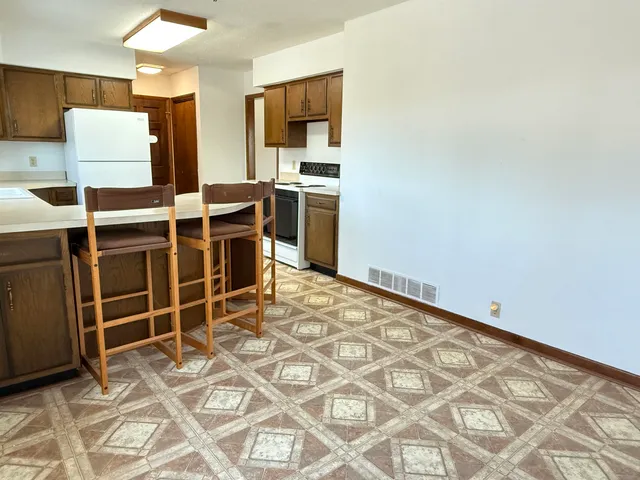 a view of an empty room with a fireplace and a window