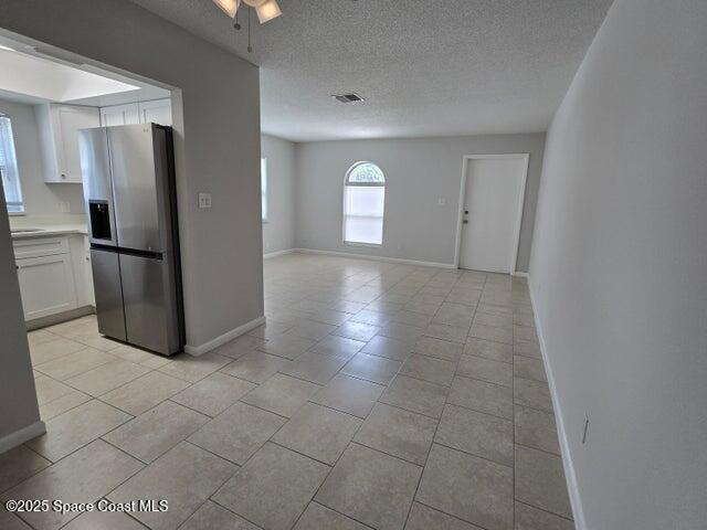 417 Audubon Drive, Unit B Melbourne, FL 32901 - Photo 4 of 12 a view of a refrigerator in kitchen and an empty room