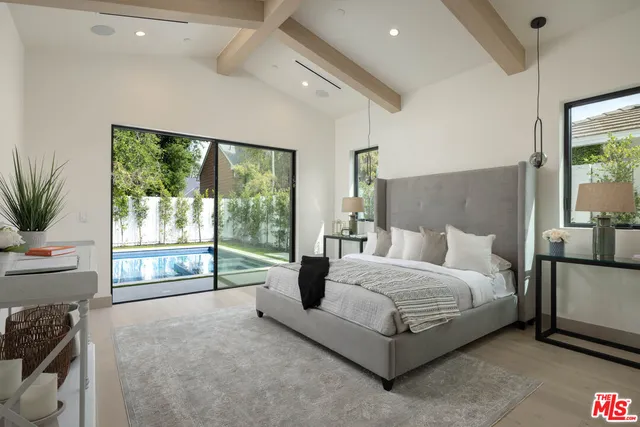 a spacious bathroom with a double vanity sink a mirror and a bathtub