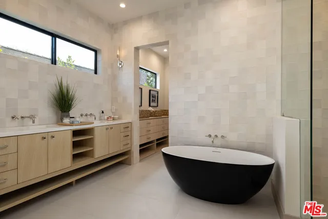 a bathroom with a bathtub and shower