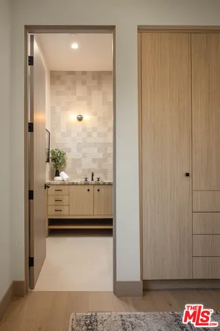 a bathroom with a granite countertop toilet a sink and a mirror
