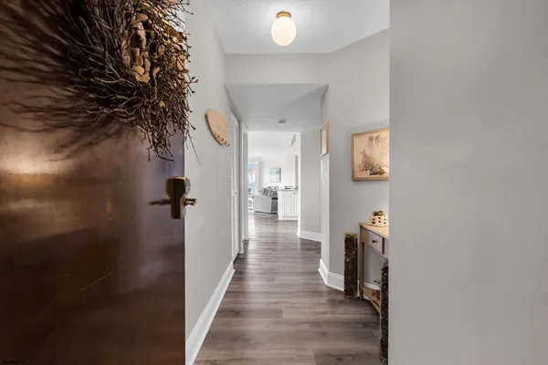 a kitchen with stainless steel appliances a sink a stove a refrigerator cabinets and a window