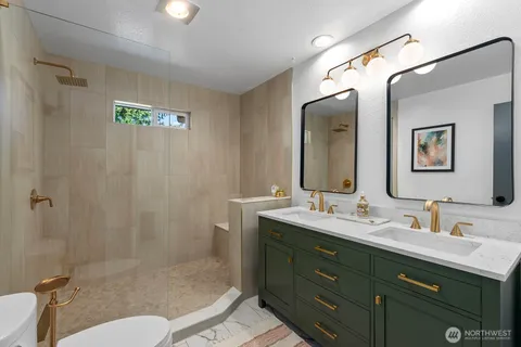 a bathroom with double vanity sink and a mirror