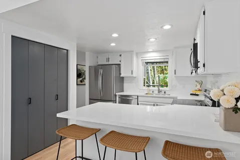 a kitchen with stainless steel appliances a refrigerator and a sink