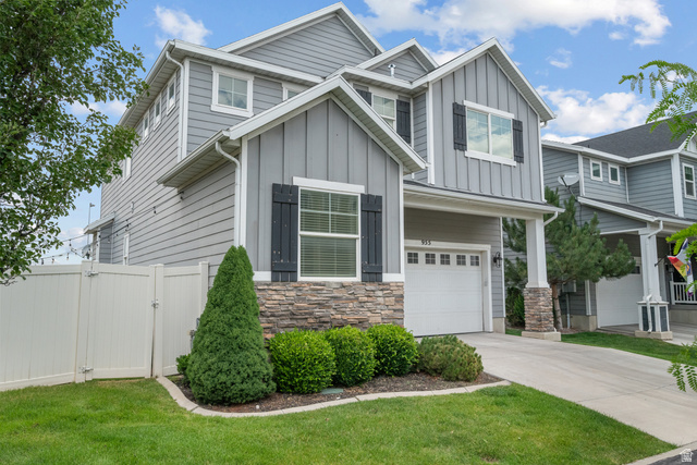 955 Delorean Lane Midvale, UT 84047 - Photo 3 of 47 Contemporary two-story residence featuring grey horizontal siding and vertical board and batten accents