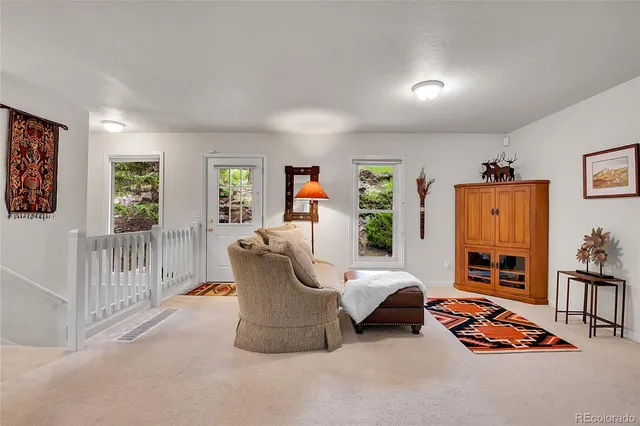 a living room with furniture a flat screen tv and a table