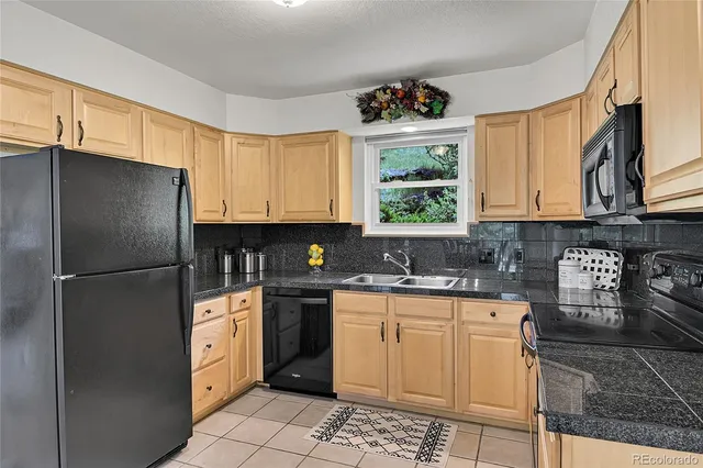 a kitchen with stainless steel appliances a refrigerator sink and cabinets