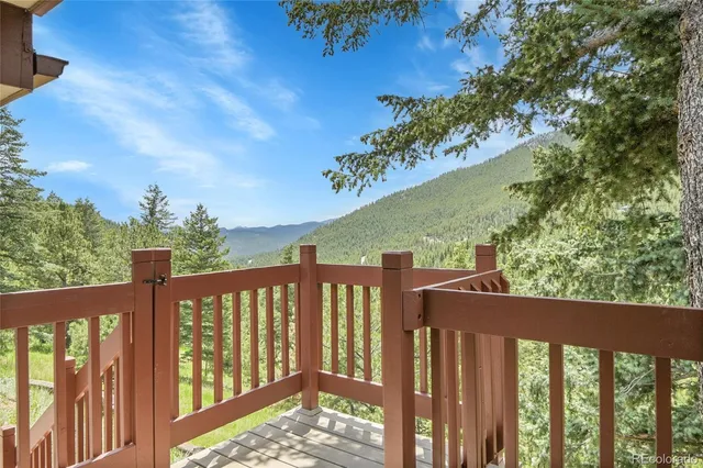 a view of a balcony with wooden fence