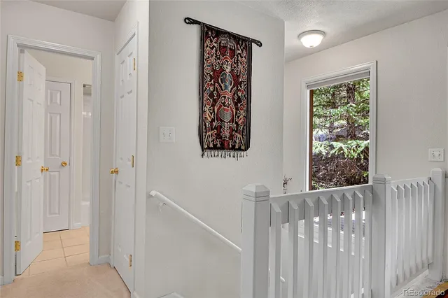 a view of a hallway with wooden floor and entryway