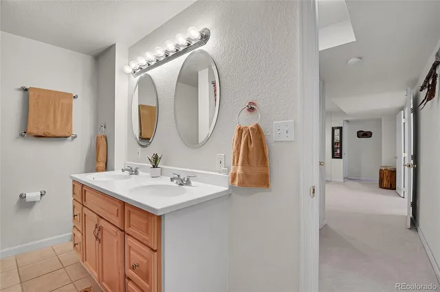 a en suite bathroom with a double vanity sink and a mirror
