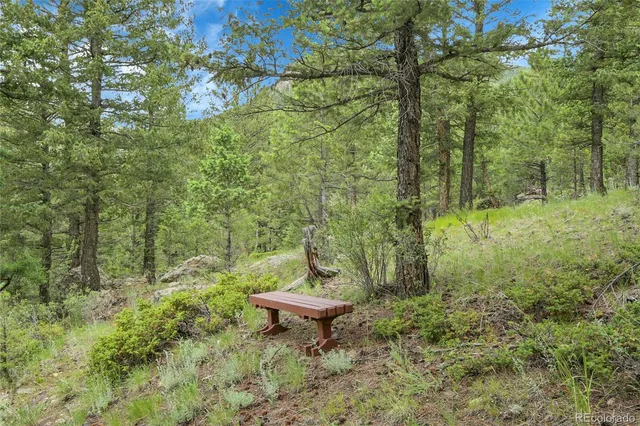 a view of a backyard with table and chairs