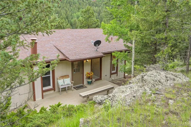 a backyard of a house with table and chairs