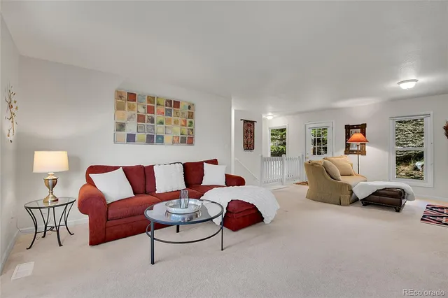 a living room with furniture and a lamp