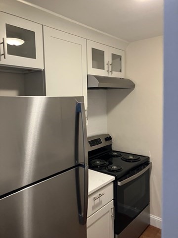 116 Trapelo Road, Unit 4 Waltham, MA 02452 - Photo 2 of 4 a stove top oven sitting inside of a kitchen