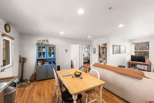a living room with furniture a flat screen tv and a table