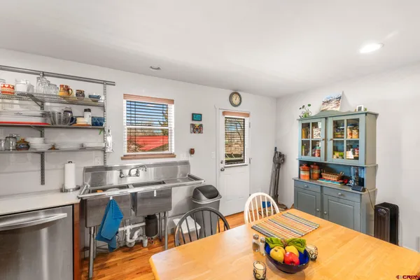 a kitchen that has a table and chairs in it