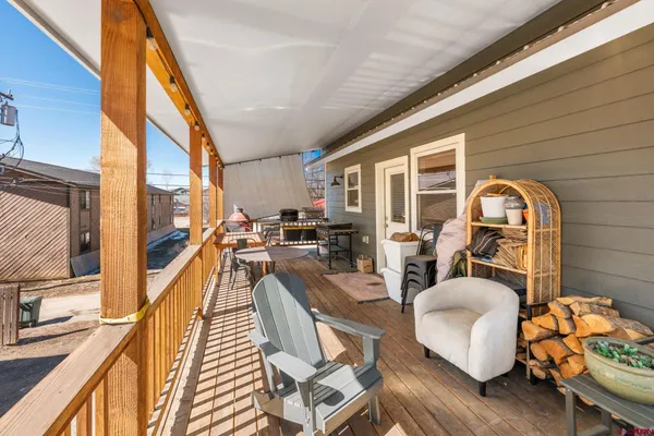 a view of a couches and dinning table in the balcony