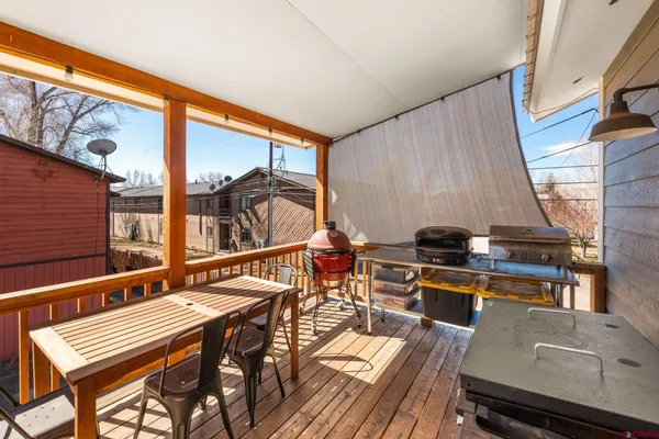 deck with table and chairs and wooden floor