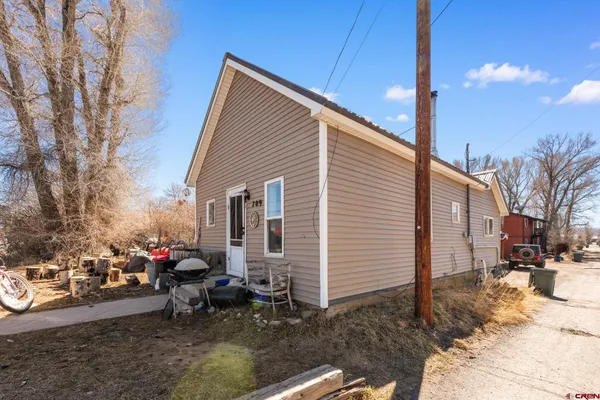 a backyard of a house with fire pit and chairs