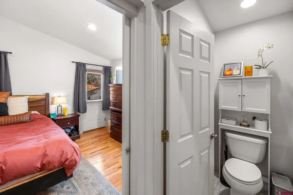 a bedroom with a bed dresser and a window