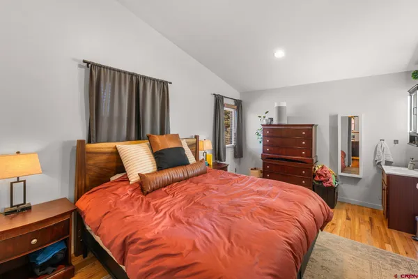 a bedroom with bed and lamp