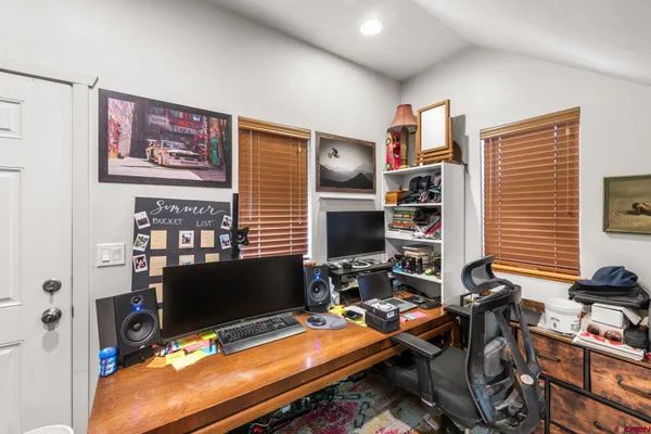 a room with furniture pool table and a flat screen tv