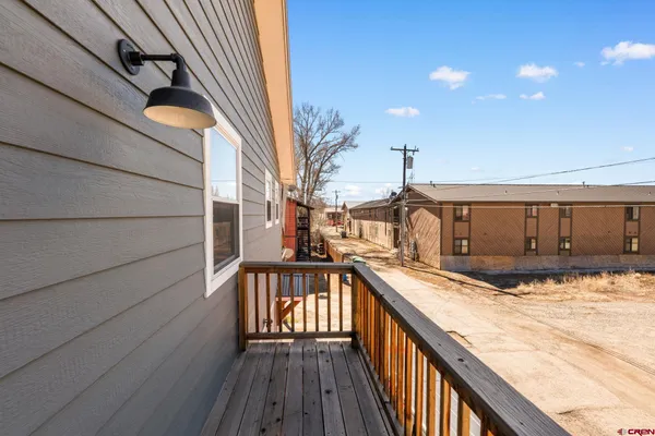 a view of a balcony with wooden floor and staircase