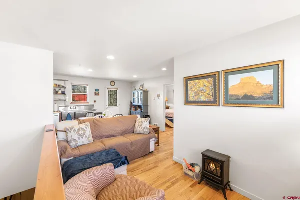 a living room with furniture and a painting on the wall