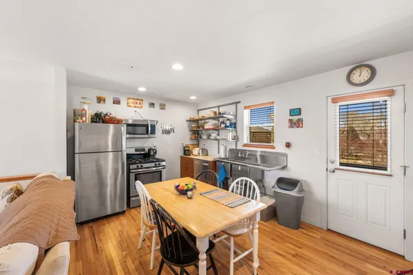 a kitchen with stainless steel appliances granite countertop a refrigerator and a stove top oven