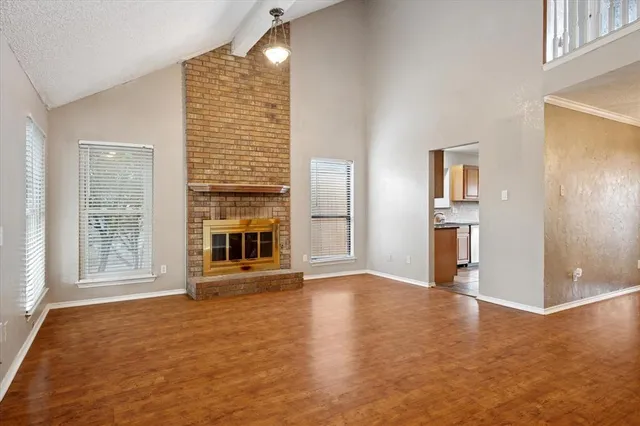 an empty room with windows and entrance