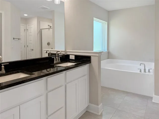 a bathroom with a bathtub and a sink