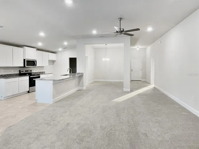 a view of a kitchen with microwave and cabinets