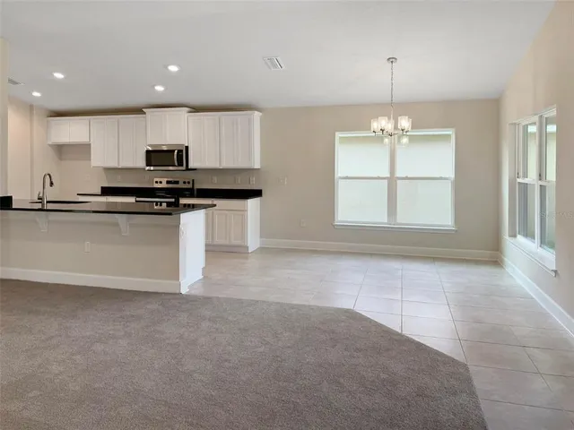 a kitchen with stainless steel appliances granite countertop a sink and a stove