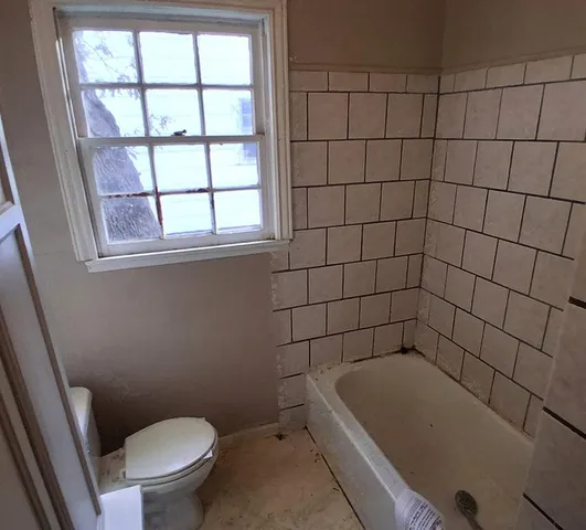 a bathroom with a bathtub and a toilet