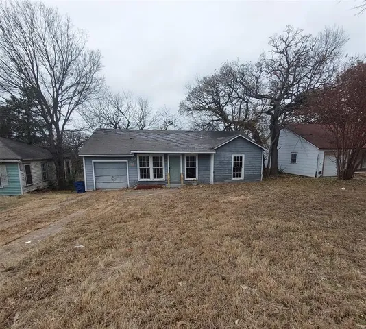 a front view of house with yard and trees
