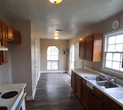 a large kitchen with a large window
