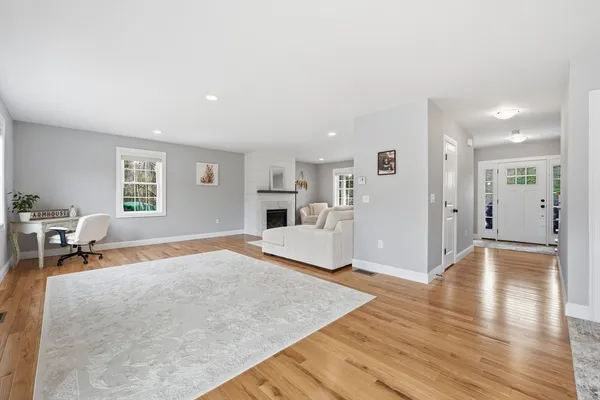 a hallway view with hardwood floor and a sink