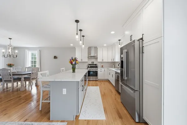 a large kitchen with kitchen island a sink stainless steel appliances and cabinets