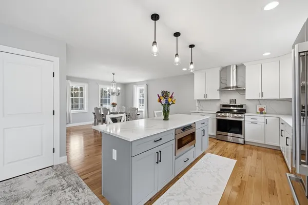 a kitchen that has a table and chairs in it