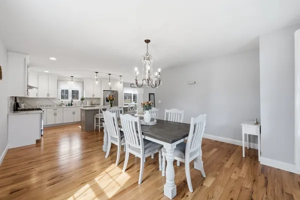 a kitchen with a sink cabinets and wooden floor