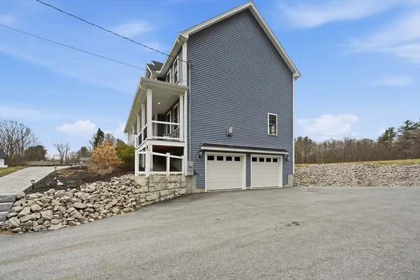 a front view of a house with a yard and balcony