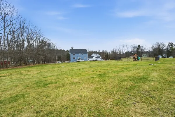 a view of a field with an trees in the background