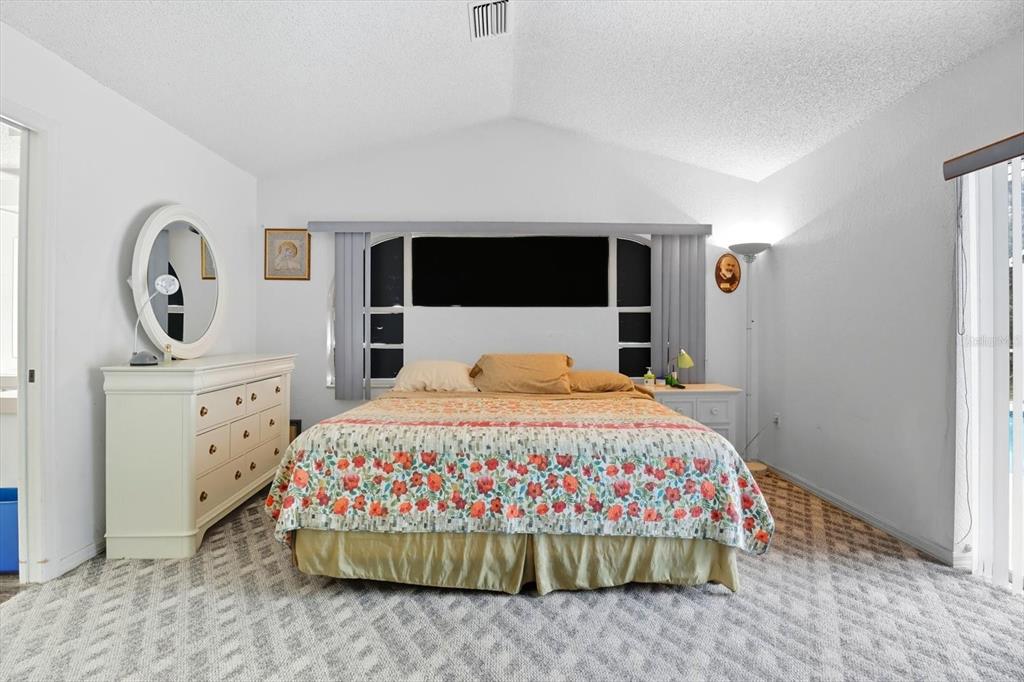 4355 West Justice Court Homosassa, FL 34446 - Photo 12 of 30 a bedroom with a bed and a dresser