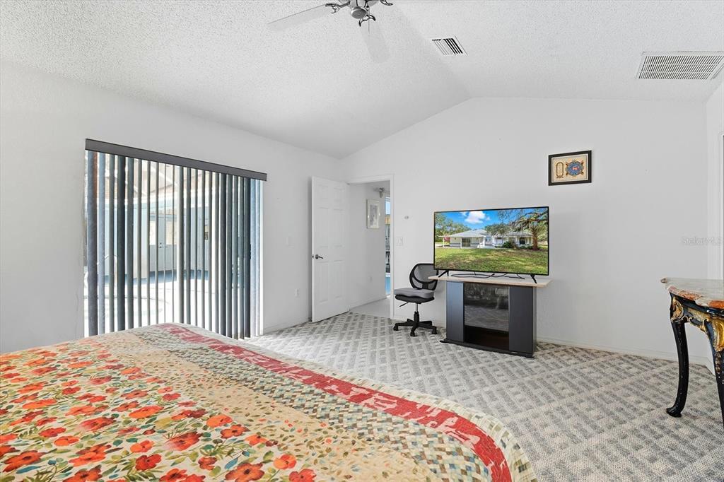 4355 West Justice Court Homosassa, FL 34446 - Photo 13 of 30 a bedroom with a bed and a flat screen tv