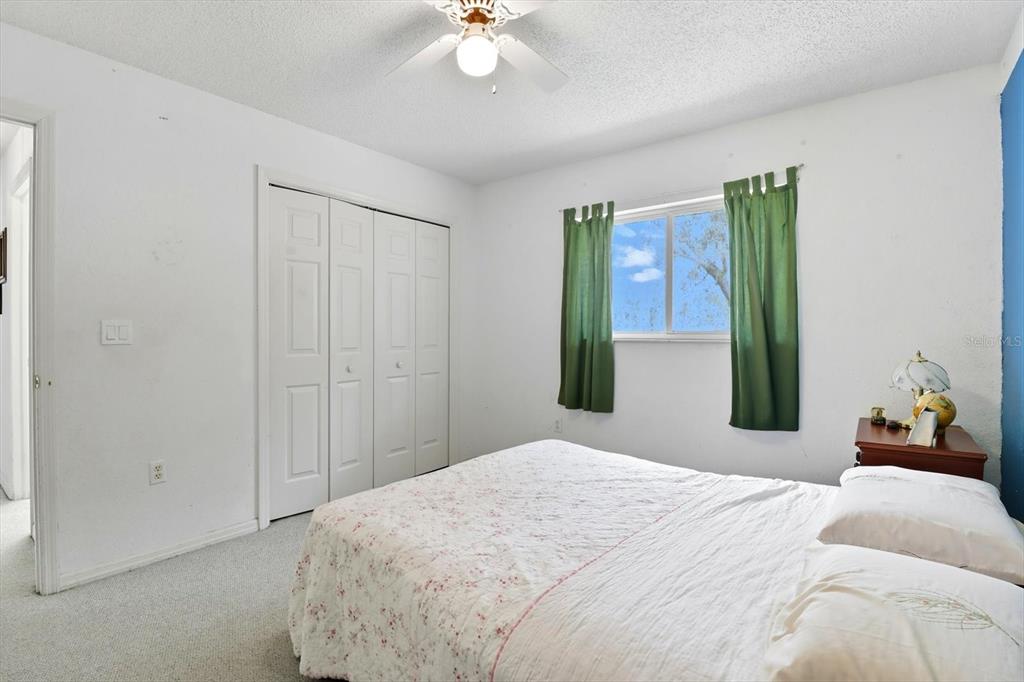 4355 West Justice Court Homosassa, FL 34446 - Photo 21 of 30 a bedroom with a bed and a chandelier
