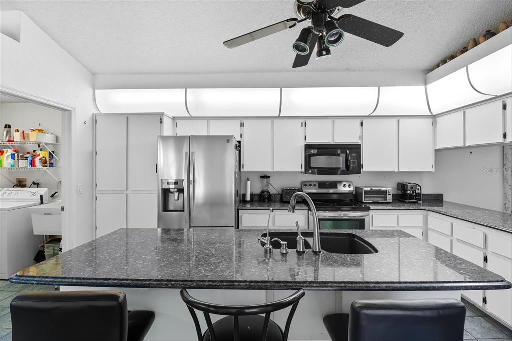 4355 West Justice Court Homosassa, FL 34446 - Photo 6 of 30 a kitchen with stainless steel appliances granite countertop a sink a stove and cabinets